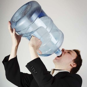Man drinking water from huge water bottle